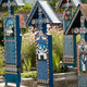 Illustration for article titled In the worlds most cheerful cemetery, the tombstones are brightly painted and jokes are written on the graves